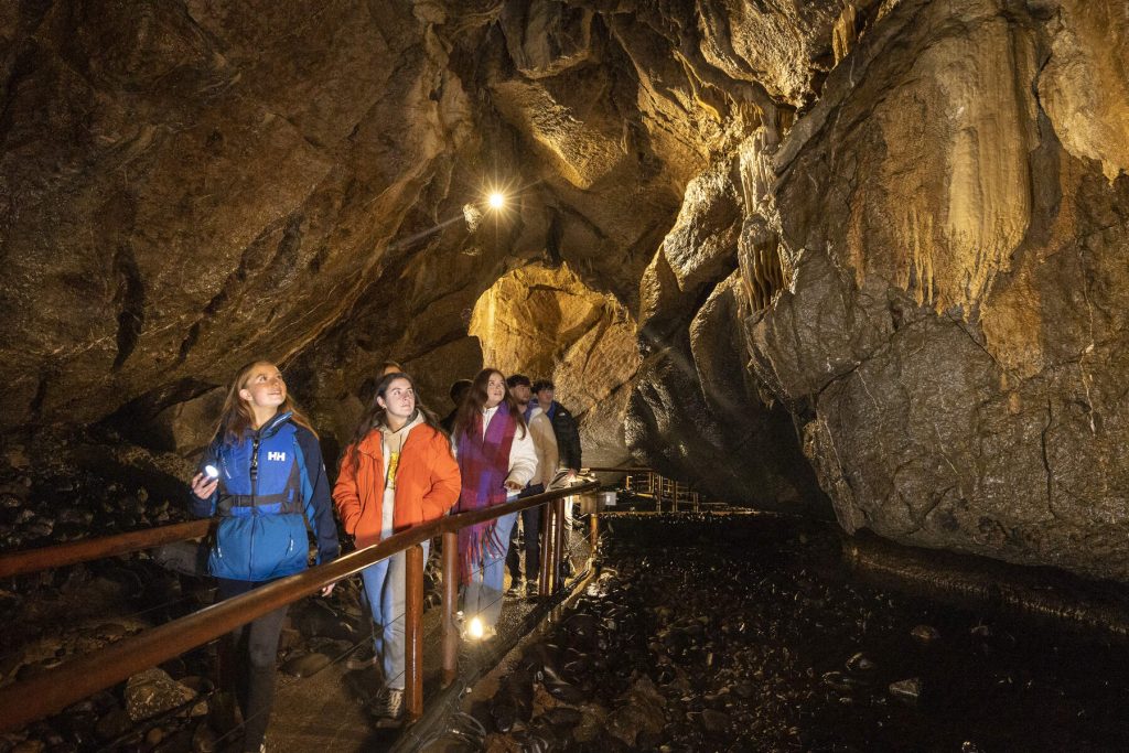 Family walks through limestone Marble Arch Caves