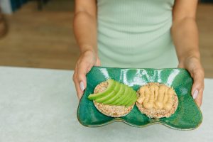 Avocado toast and peanut butter rice cake for breakfast