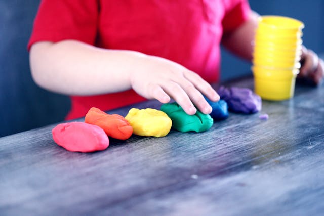 Child playing with coloured play dough