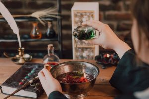 child pouring potions into  cauldron 