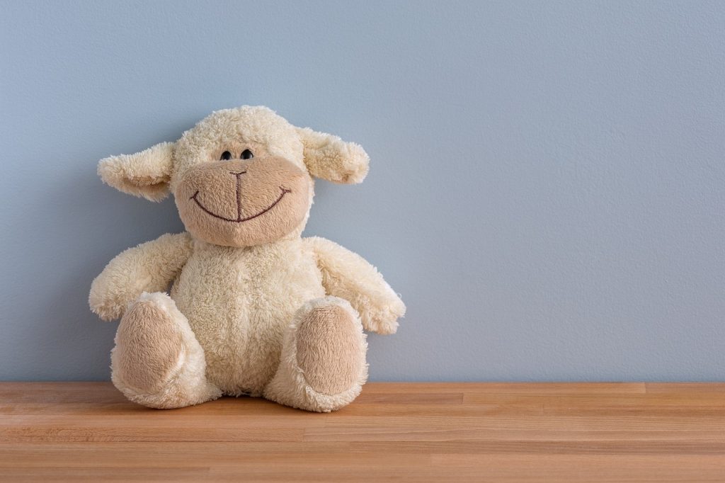 Smiling soft toy sitting on a shelf