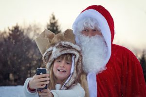 Child and Santa posing for selfie in the show