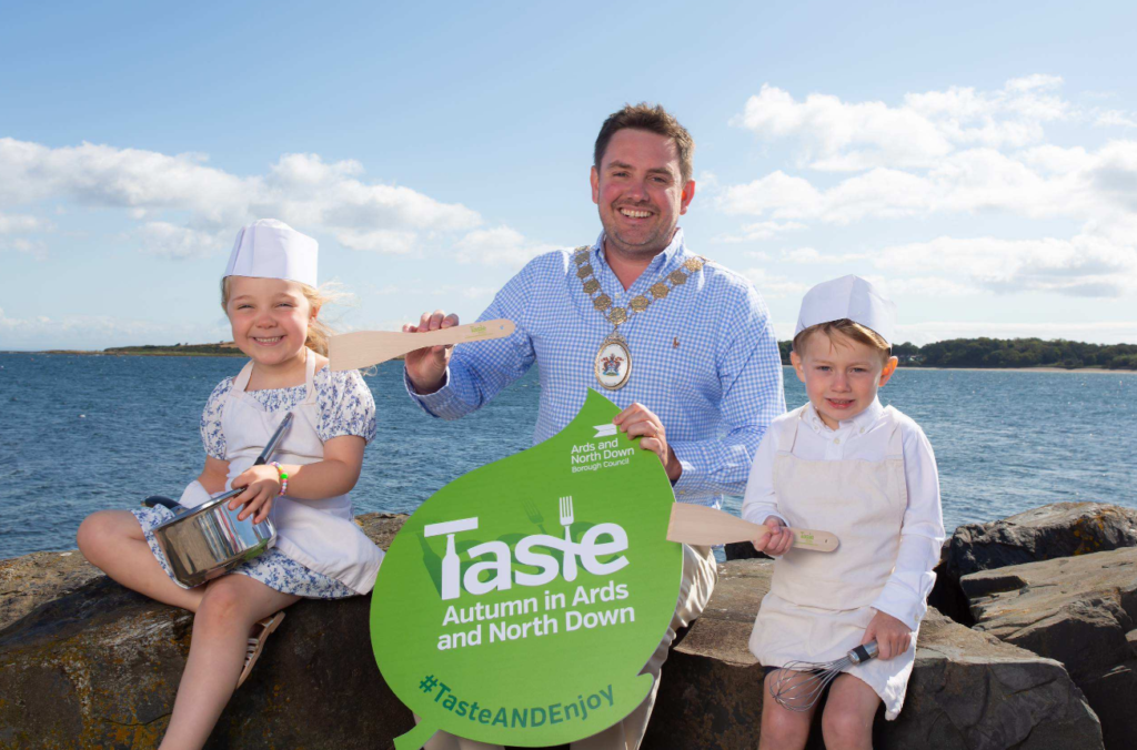 The Mayor of Ards and North Down, Councillor Craig Blaney, alongside Lily and Elliot, helping launch Taste Autumn 2026, a celebration of local food and drink taking place across the Borough from 11-27 September.